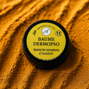 boite en aluminium noir avec une étiquette jaune et le logo artno sur font de sable